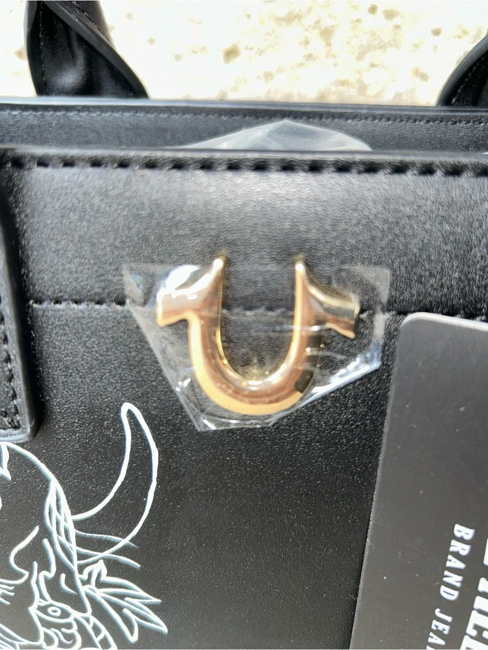 True Religion Black Satchel with White Graphic Demon Motif
